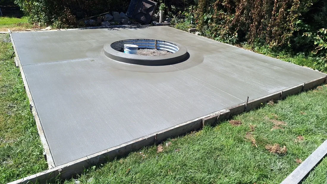 Concrete pad with a circular fire pit feature