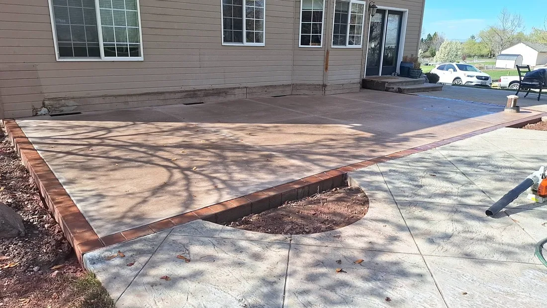 Large finished concrete patio beside a home