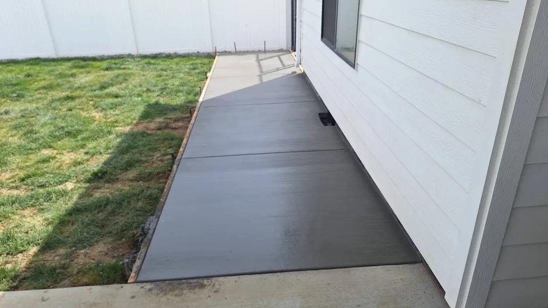 Long newly poured concrete walkway with control joints